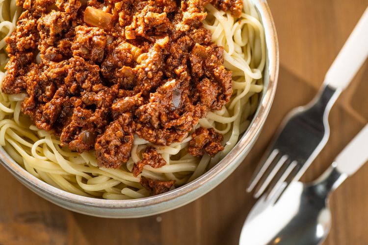 Top view of a walnut bolognese with pasta
