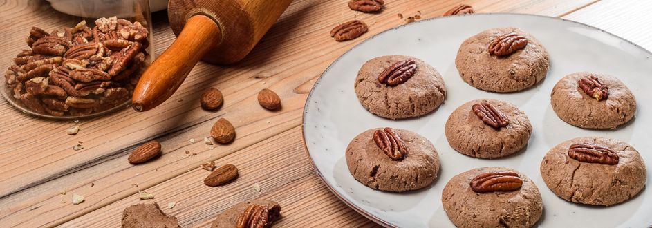 farmerssnack_vegane_nuss_cookies_pekannuss_1.jpg Mehrere Nuss Cookies Pekannuss auf einem Teller